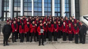 Members of the BHS band hold up a plaque