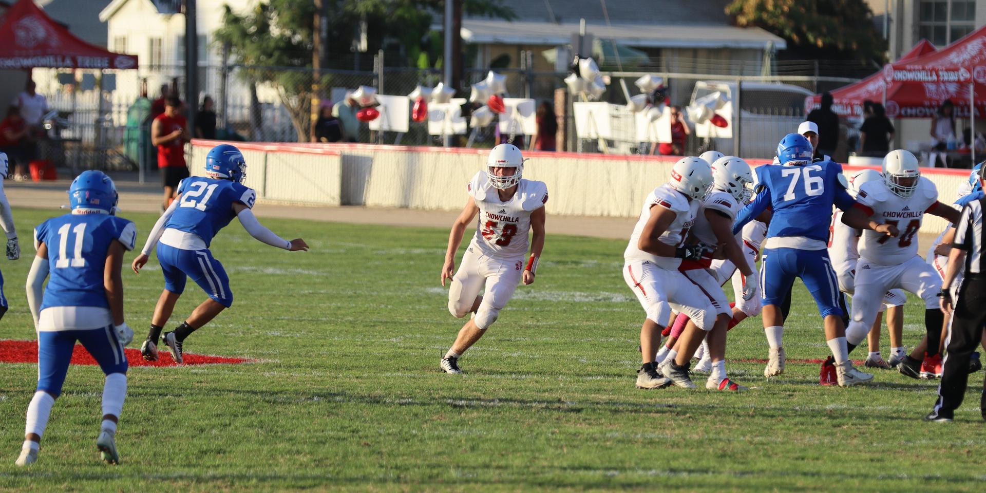 Junior Varsity football players in action against Caruthers