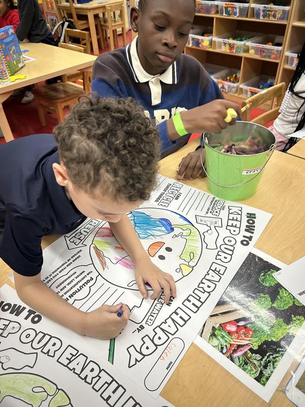 Middle school student working with the younger students