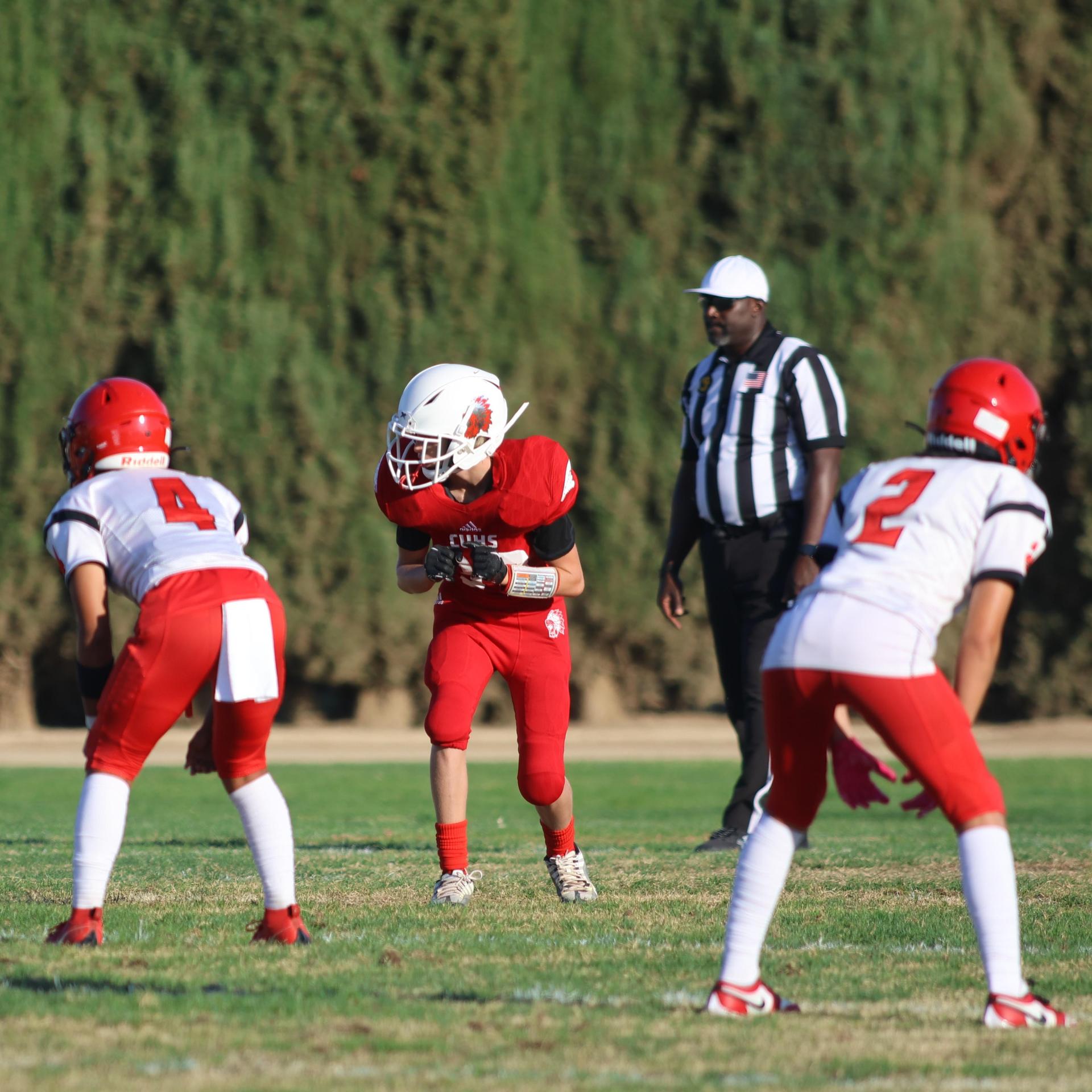 junior varsity football players in action against Fowler