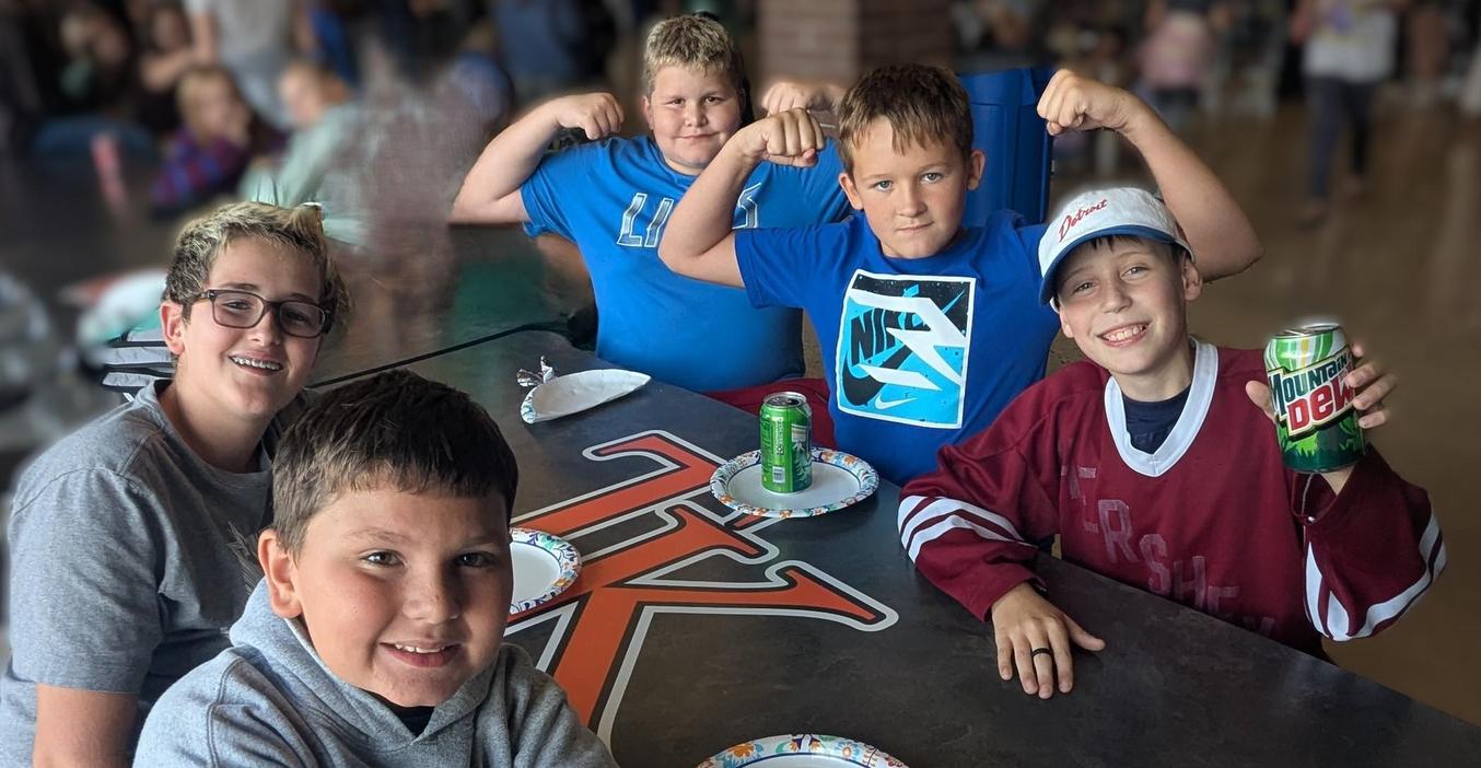 A group of boys enjoy pizza and pop at the MS Activity event.