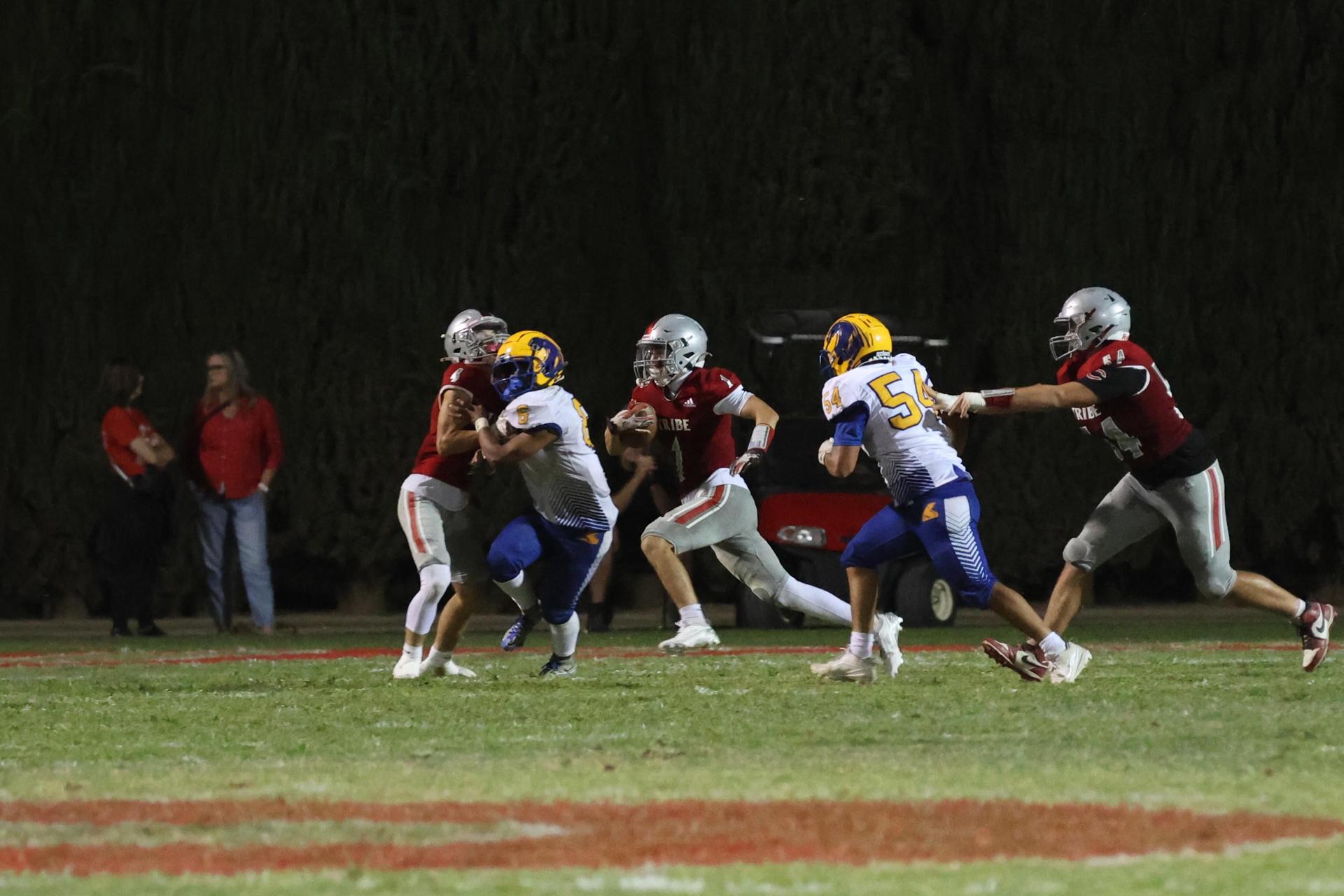 Varsity football players in action against Parlier 41