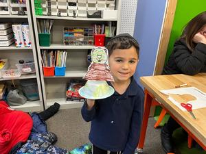 A kindergarten boy with a groundhog model