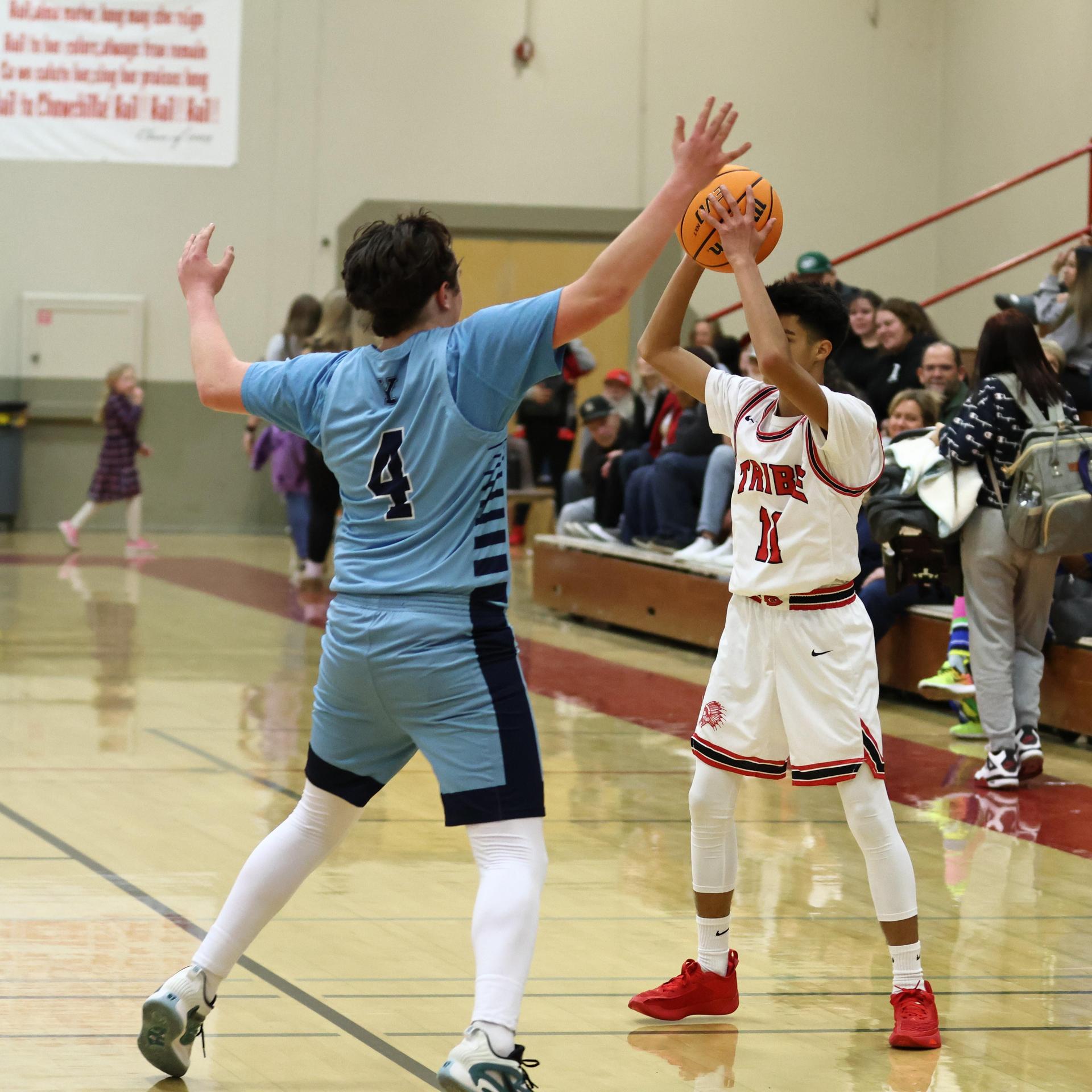 Varsity boys playing basketball against yosemite