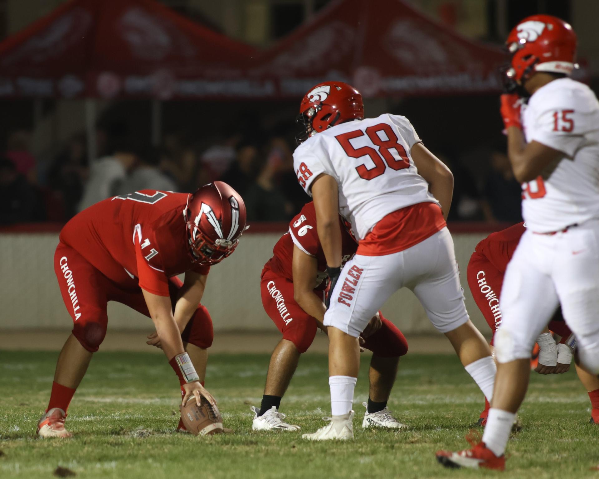 varsity boys playing football against Fowler