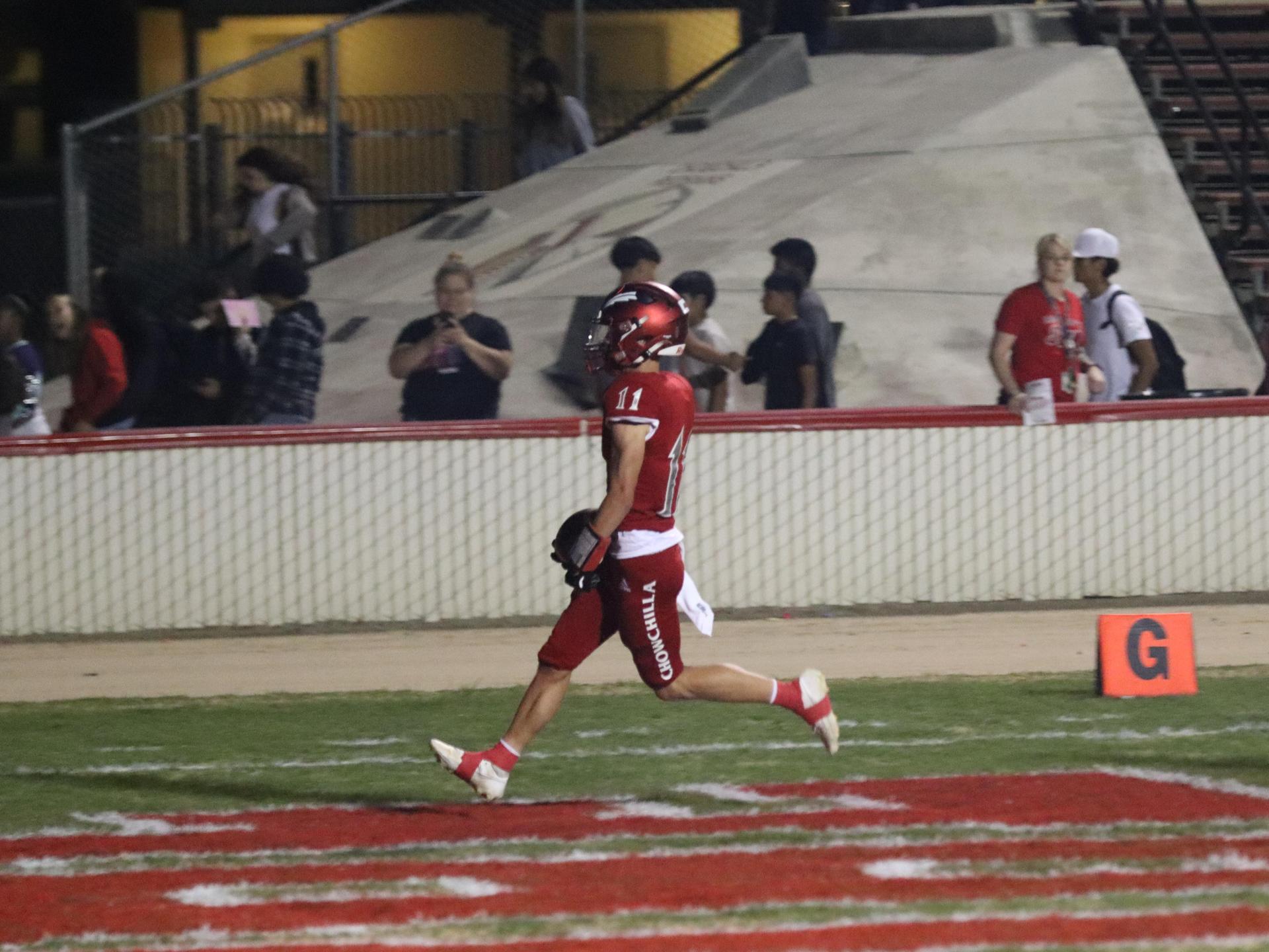 varsity football players in action against Riverdale