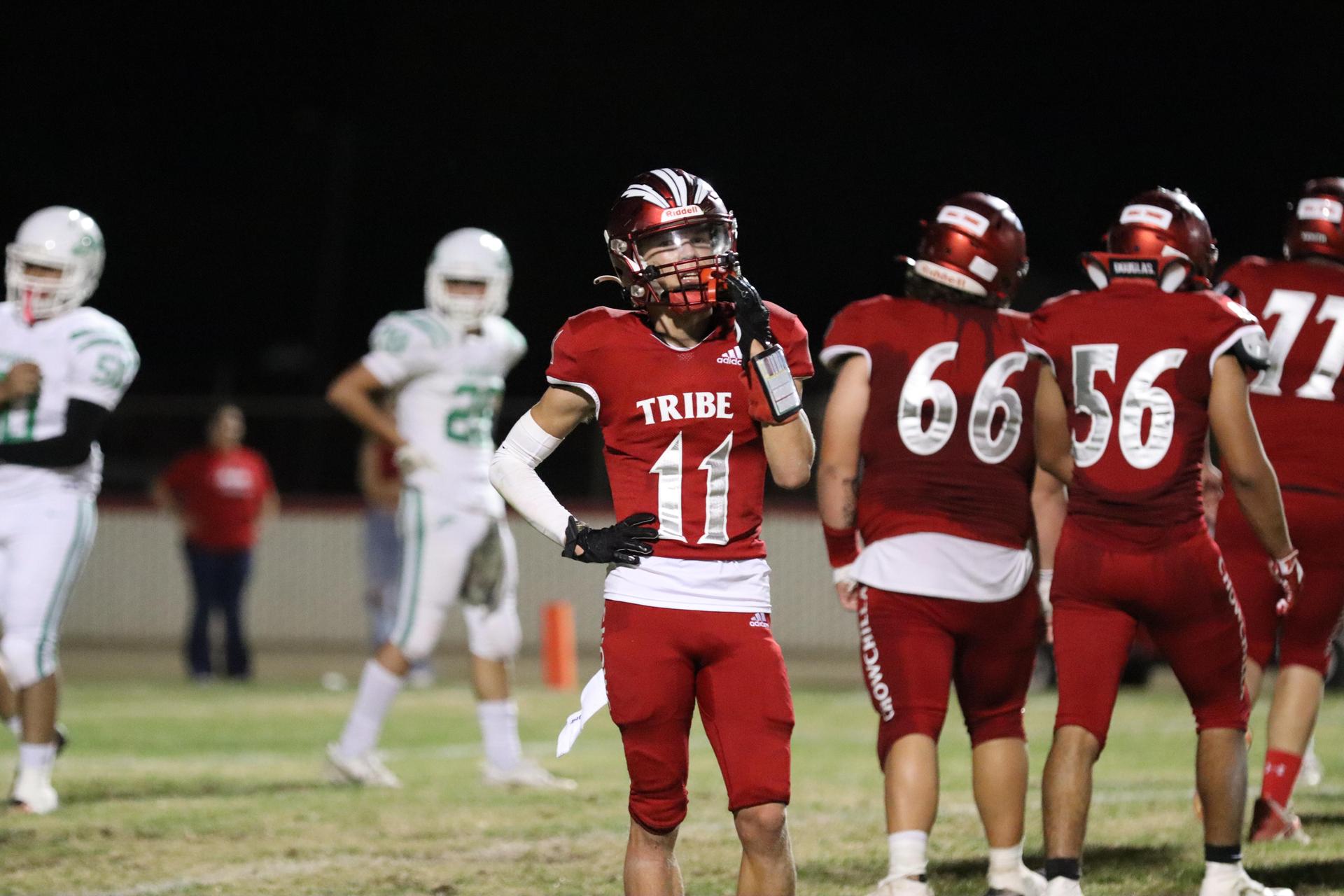 varsity football players in action against Riverdale