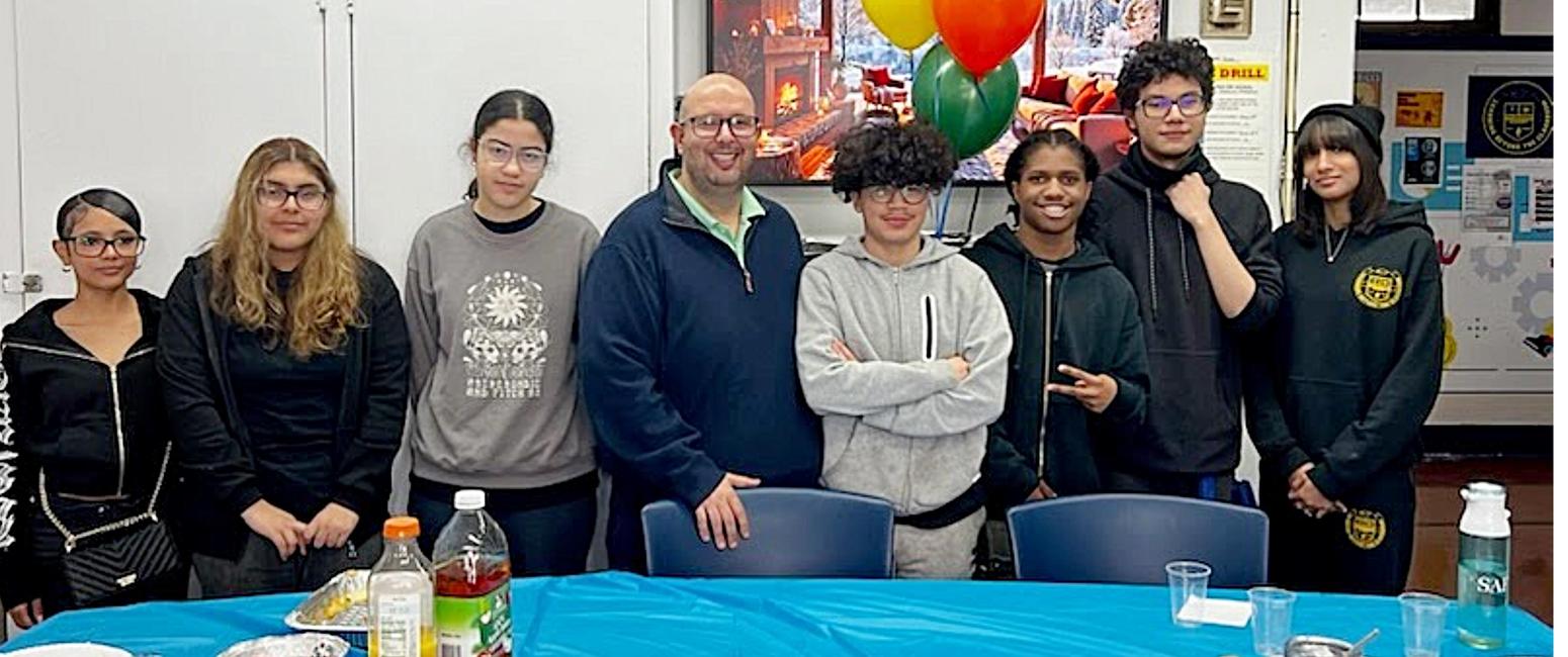 Seven high school students standing with principal Remeika.  Three female on the right and four males on his left.