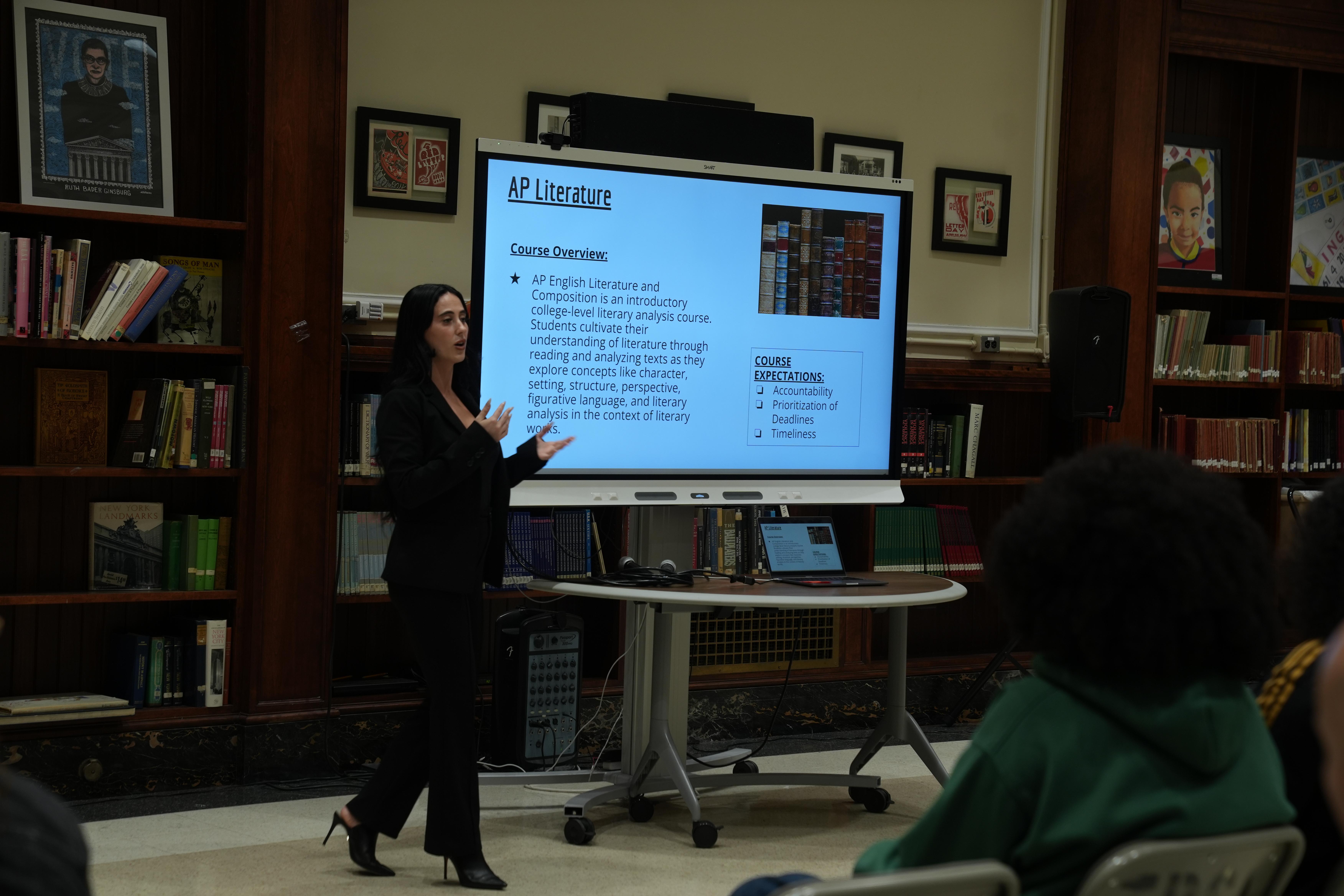 White woman with black hair presenting on AP Literature