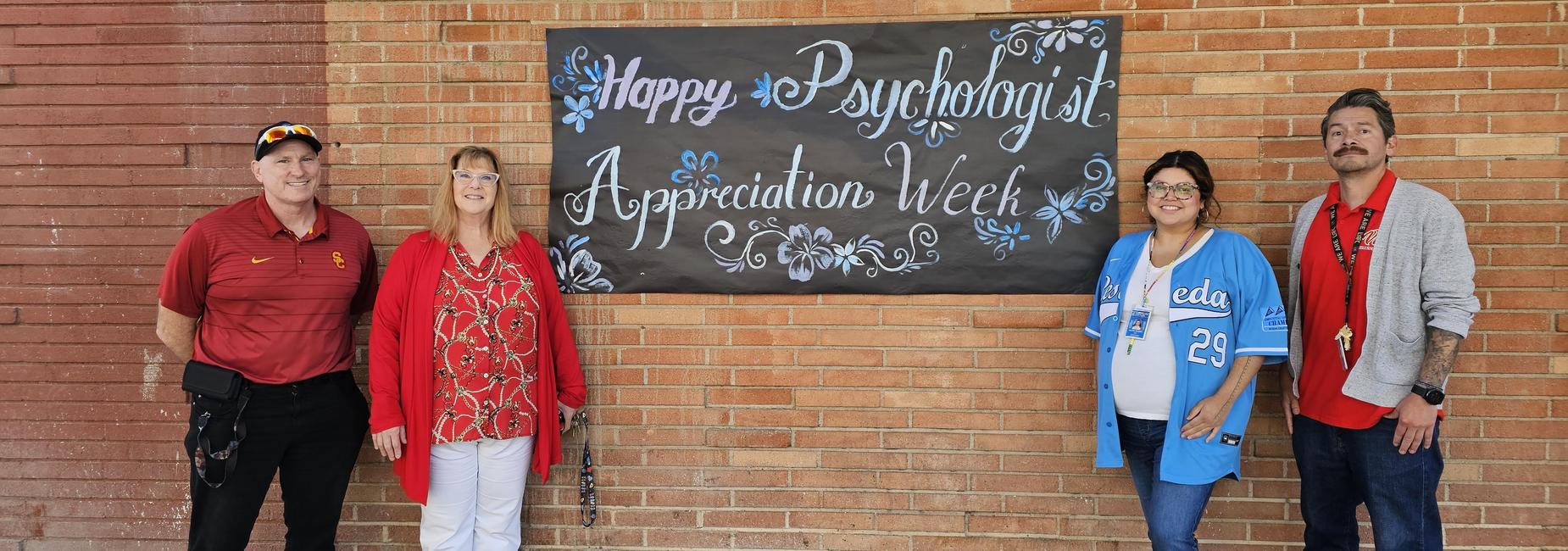 4 staff stand in front of a sign saying "Happy Psychologist Appreciation Week".