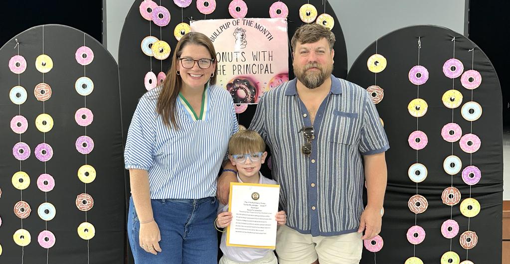 Child with parents at student of the month celebration