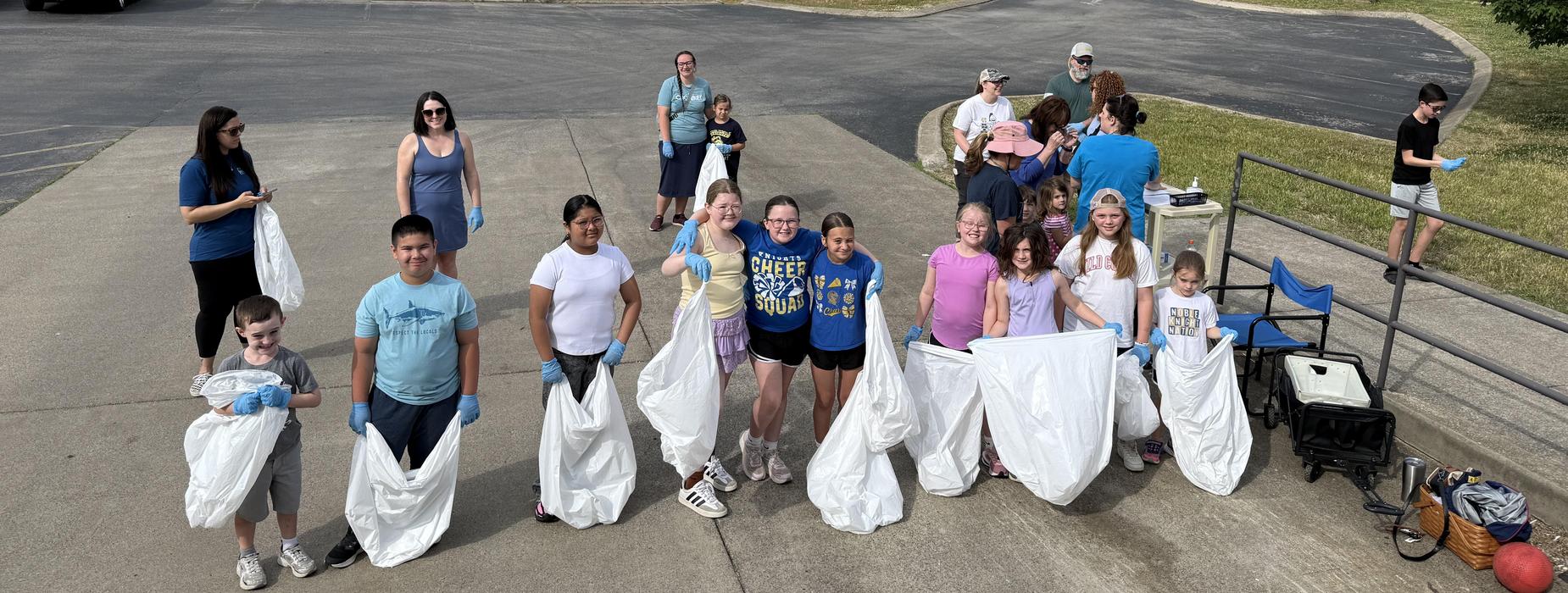 Group of people participating in a community cleanup event outdoors.