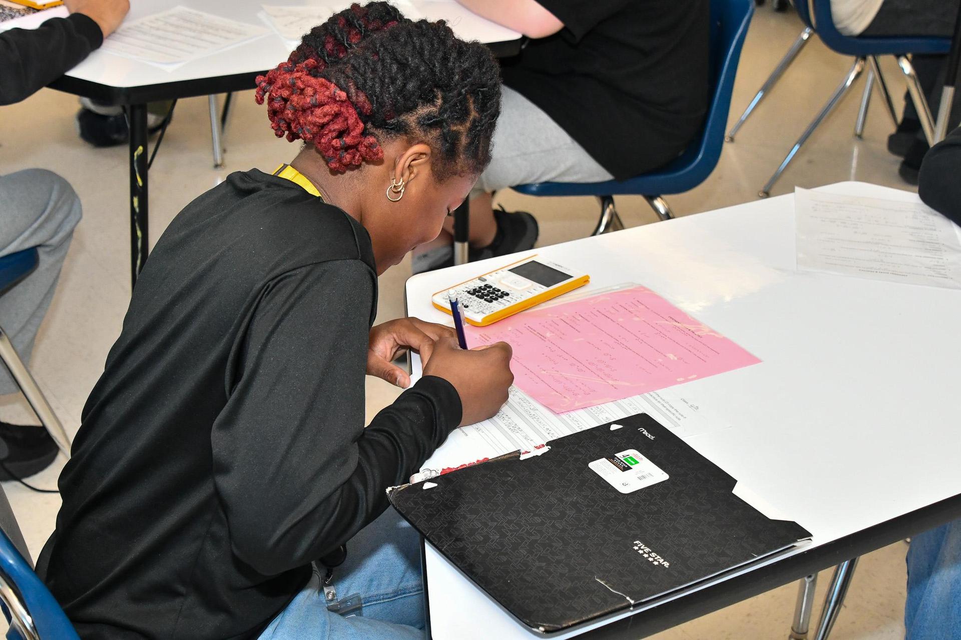 student working on math worksheet