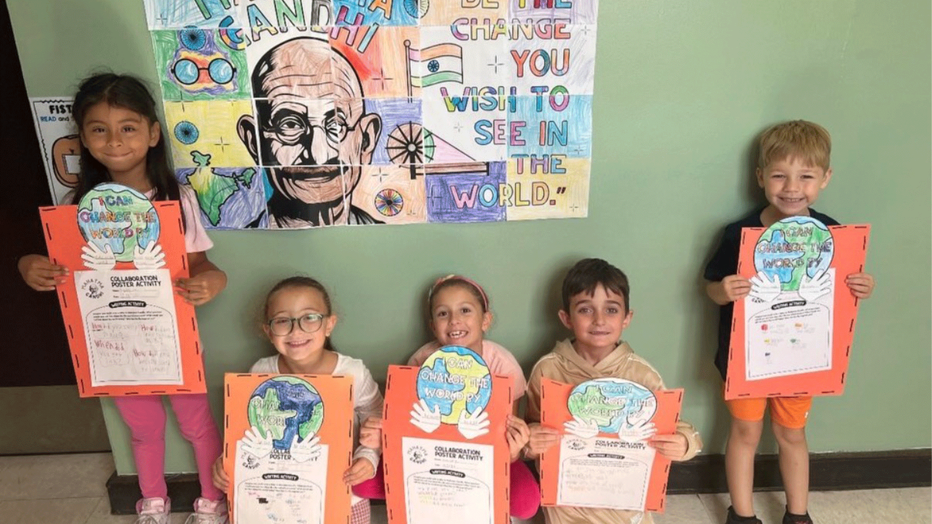 Students in the hallway holding art projects