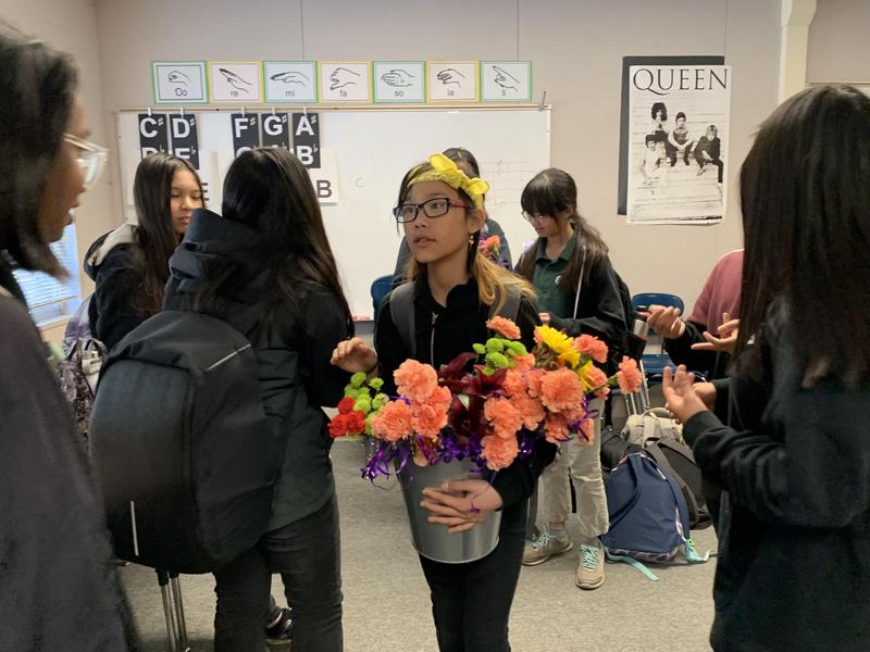 Students giving flowers to other students