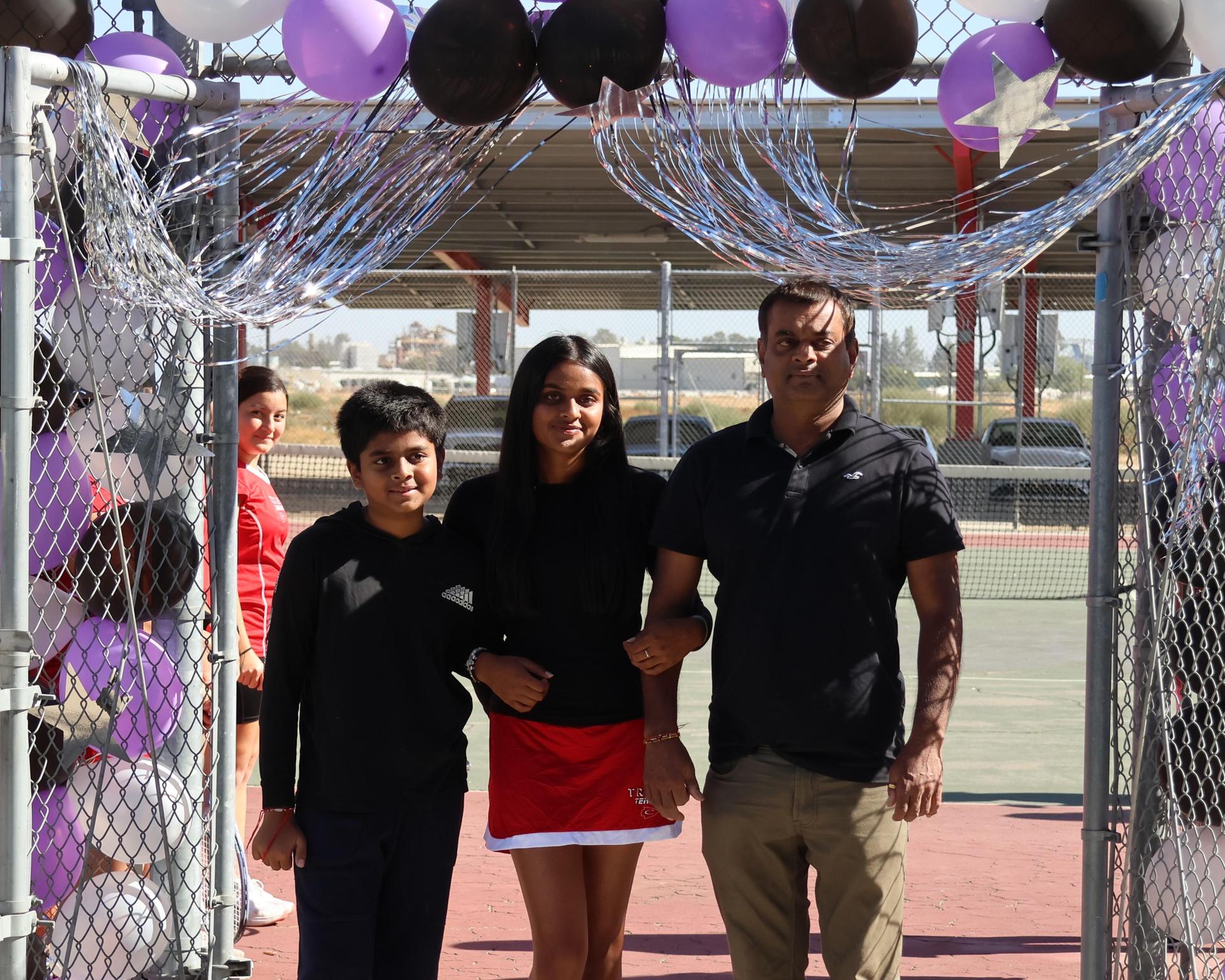 tennis players, family, and staff celebrating senior night