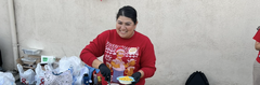 Woman serving corn at a festive table decorated with holiday elements.