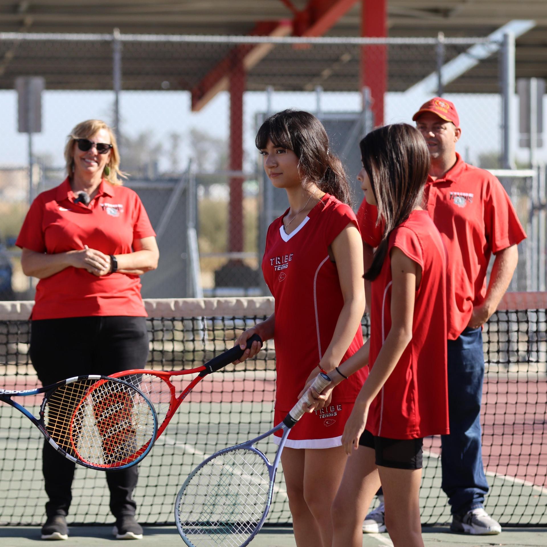 tennis players, family, and staff celebrating senior night