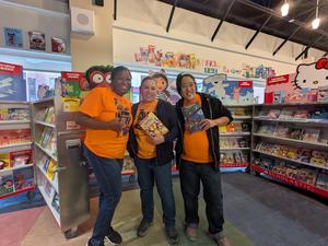 Members of FEA hold up books at the Elementary School Library