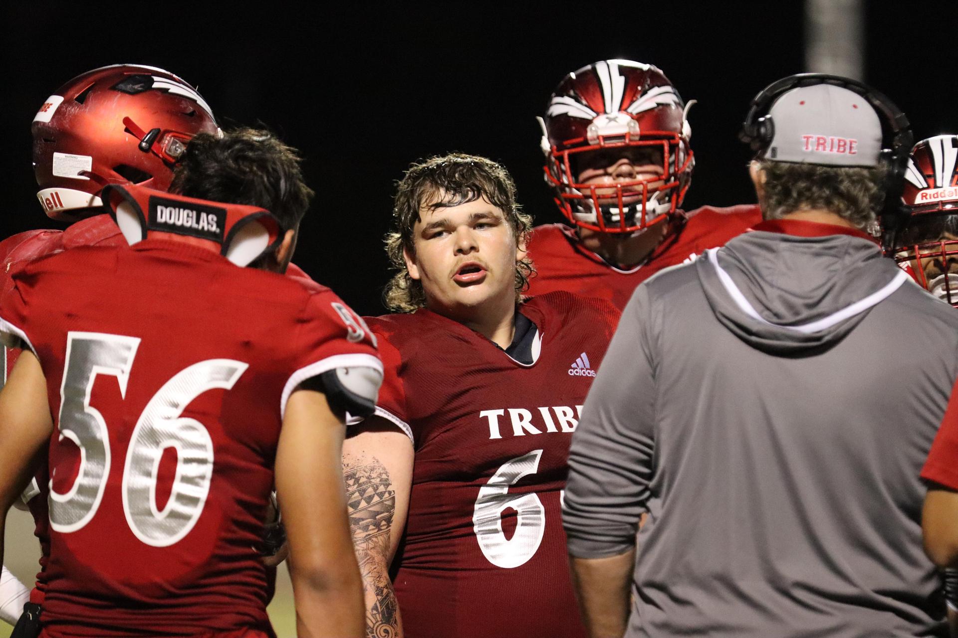 varsity football players in action against Riverdale