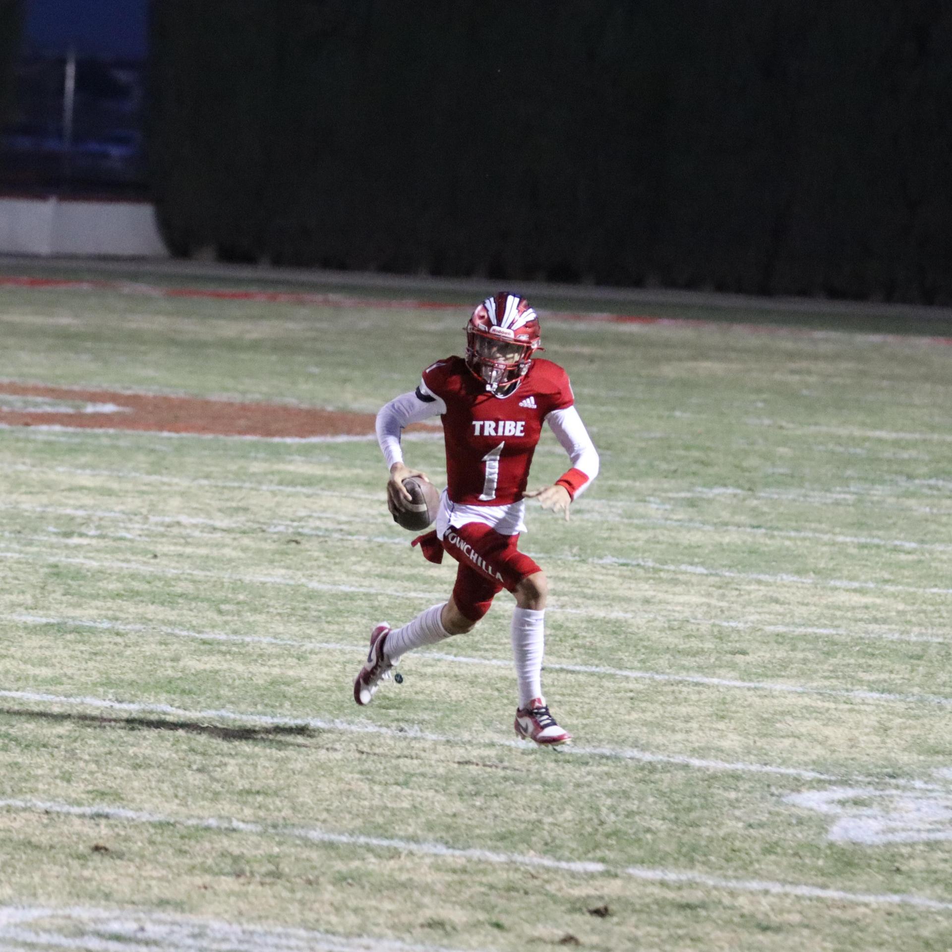 varsity football players in action against Riverdale