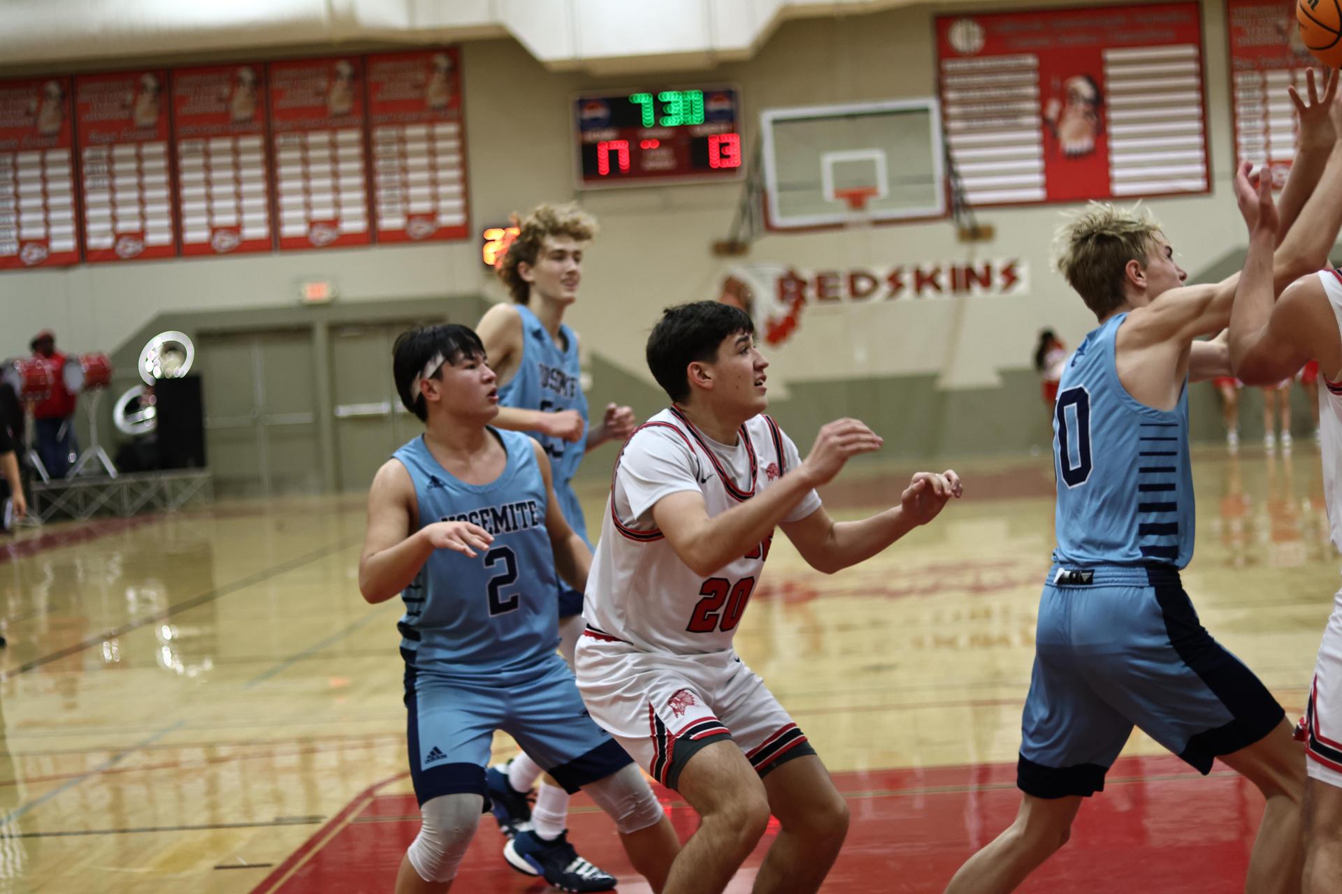 Varsity boys playing basketball against yosemite