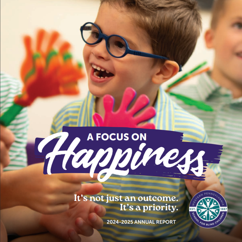 “Smiling child with glasses playing with colorful hand-shaped toys, with text reading ‘A Focus on Happiness’ and the Western Pennsylvania School for Blind Children logo.”