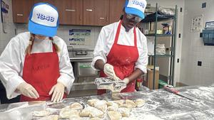 Students cooking pastries or bread