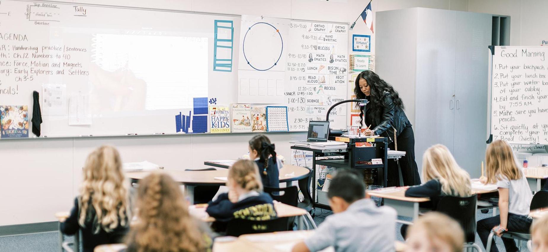 Teacher leads a lesson while elementary students work at their desks at Founders Classical Academy &ndash; Bastrop