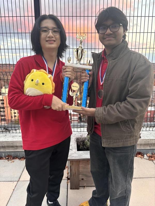 Studets holding a trophy.