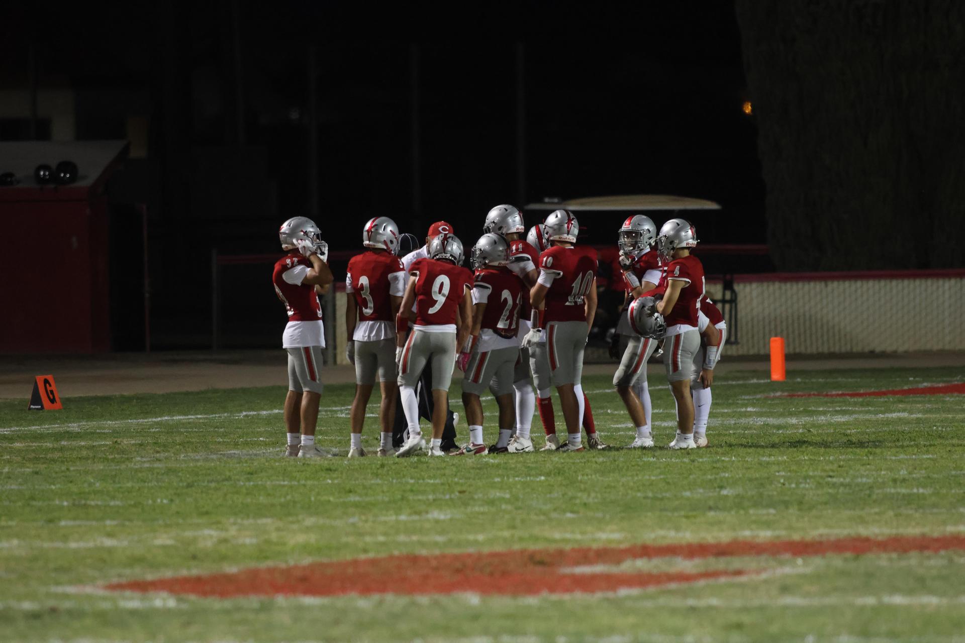 Varsity football players in action against Parlier 142