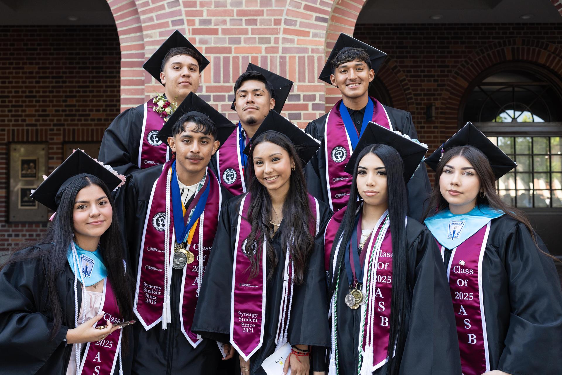 Synergy Quantum Academy graduates pose in their caps and gowns on graduation day 2025.