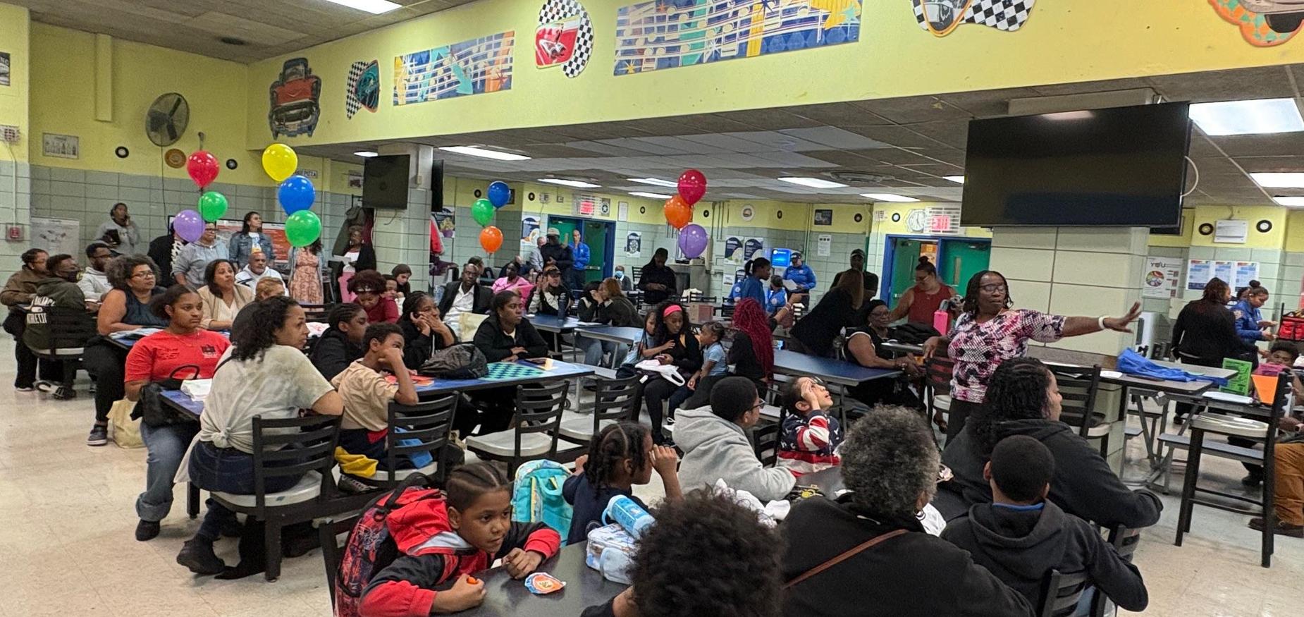 group of people sitting in the school cafeteria