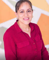 Smiling woman in a red blouse against an orange and green background.