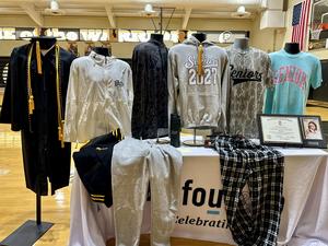 Table showcasing the apparel and cap and gown.