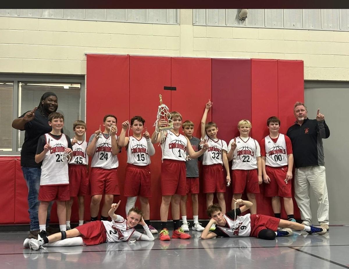St. Louis 6th grade boys basketball team posing together after tournament.