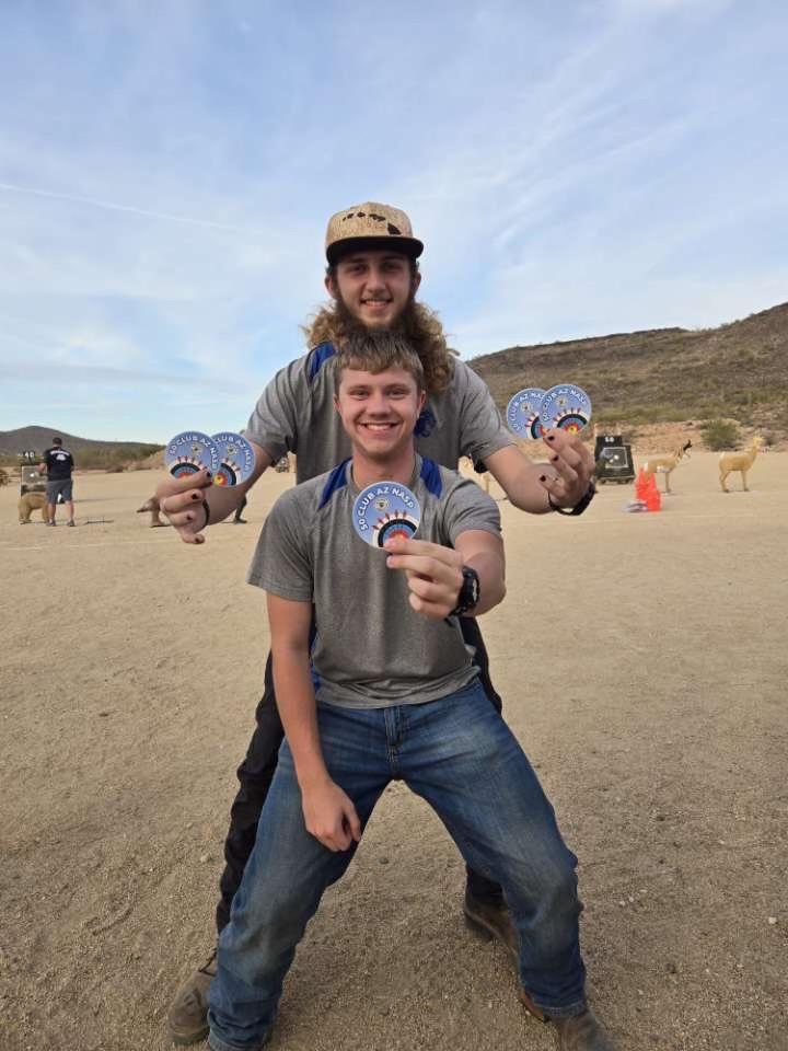 two archery participants posing for a photo after a competition