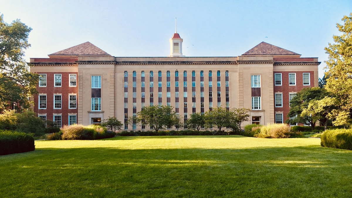 Large multistory building with a lawn in front