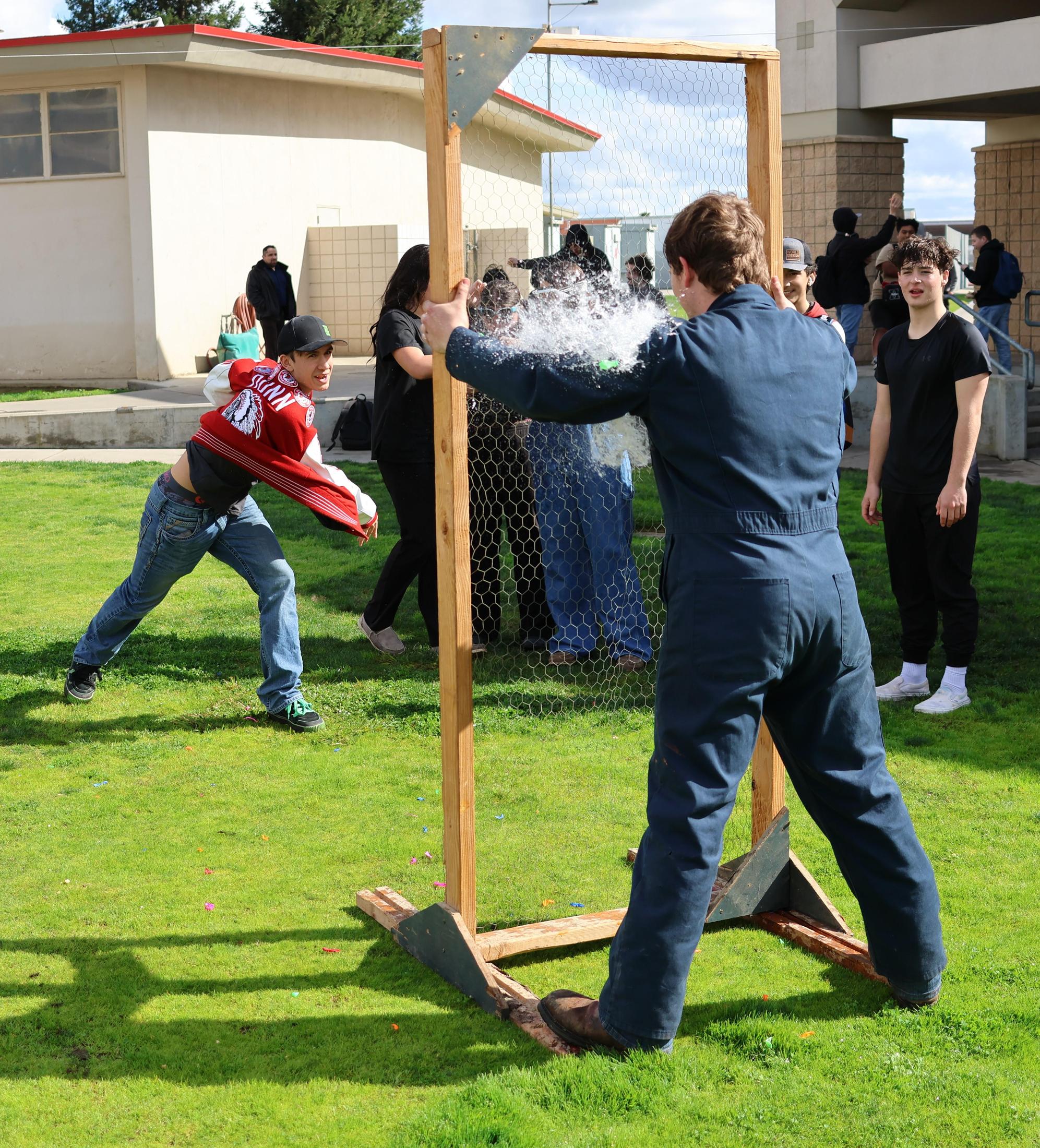 students and staff enjoying the water balloon toss