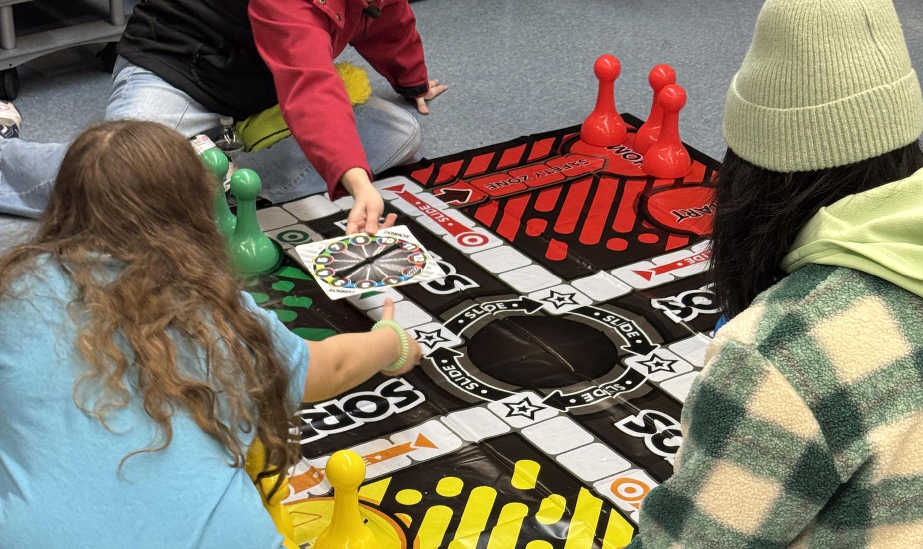 Floor sized game Sorry with 3 people playing.