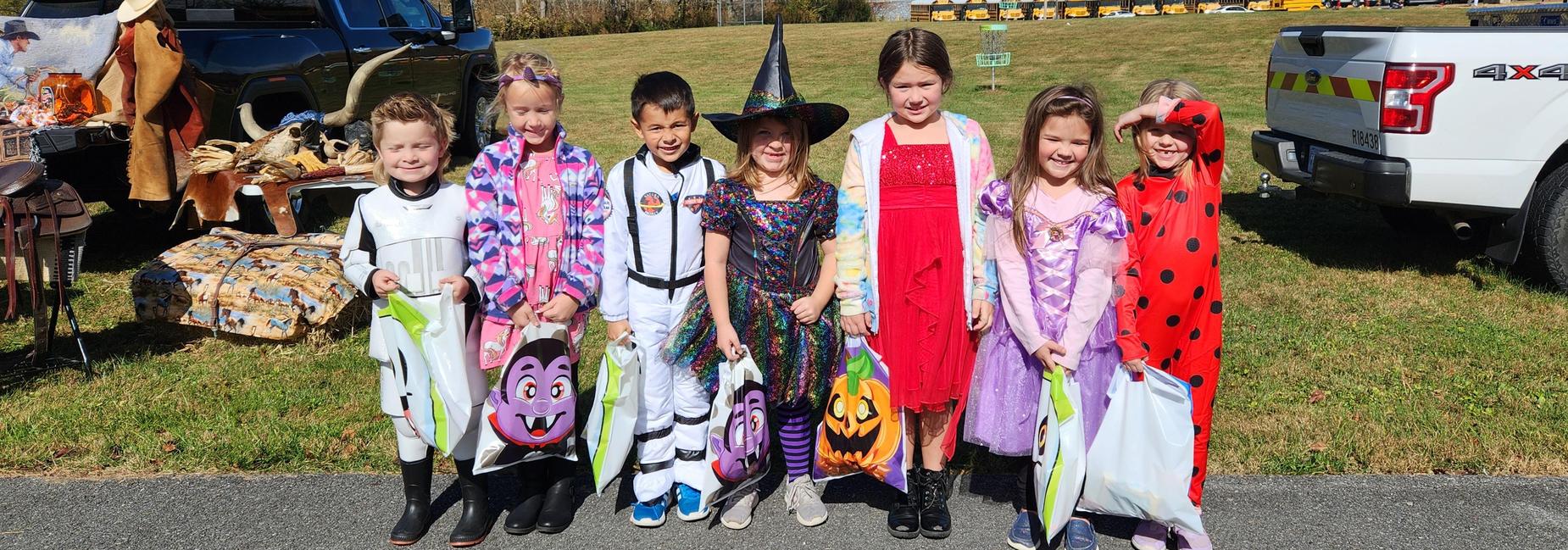 1st graders Dressed in Halloween costumes paused for a photo during Trunk or Treat