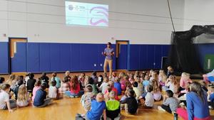 Stanley Tucker interacts with students during a lively assembly in the Penn Yan Elementary gym, encouraging them to embrace reading and share their own stories.