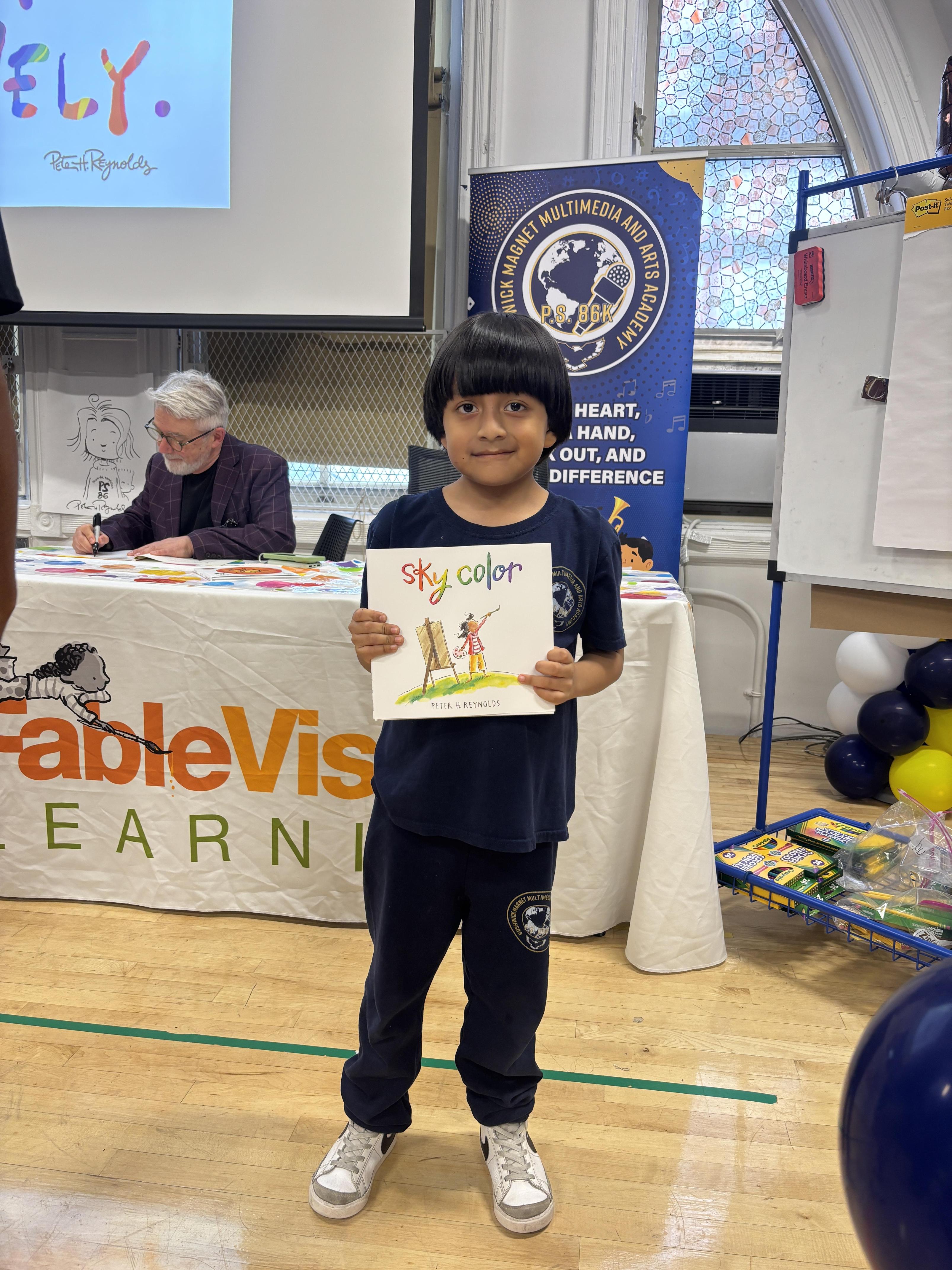 student holding book with author