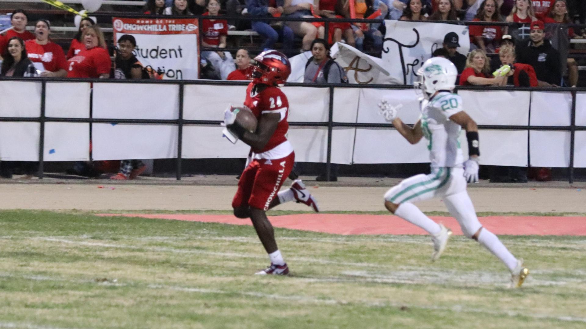 varsity football players in action against Riverdale