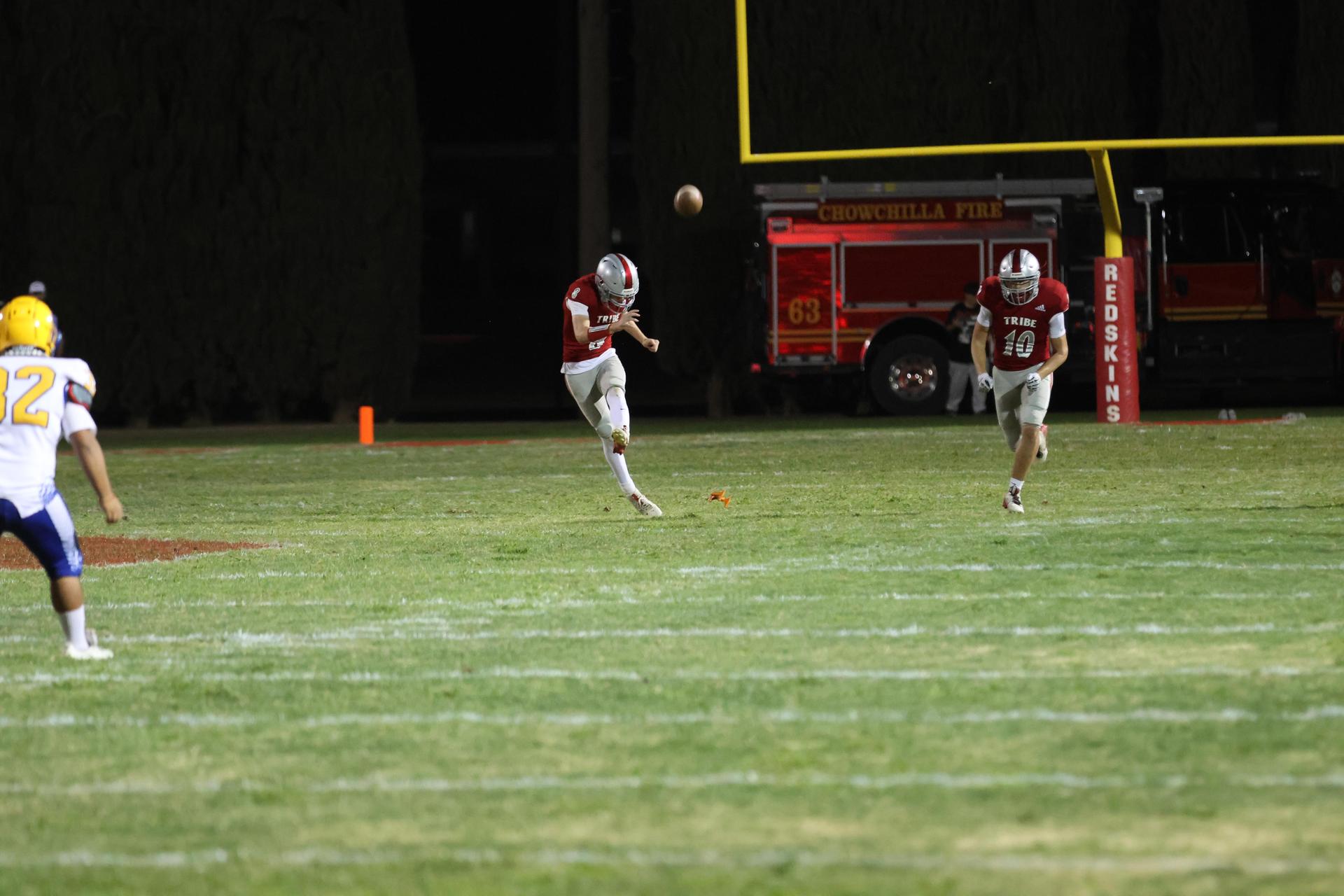 Varsity football players in action against Parlier 94