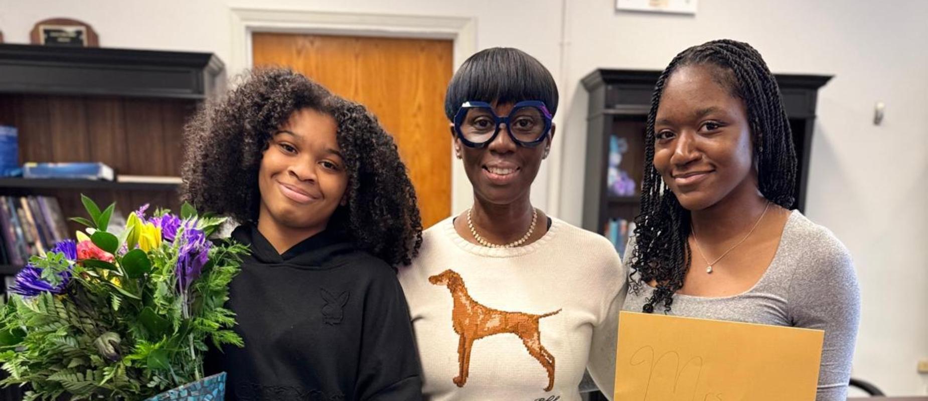Principal Thomas-Daley with two seniors