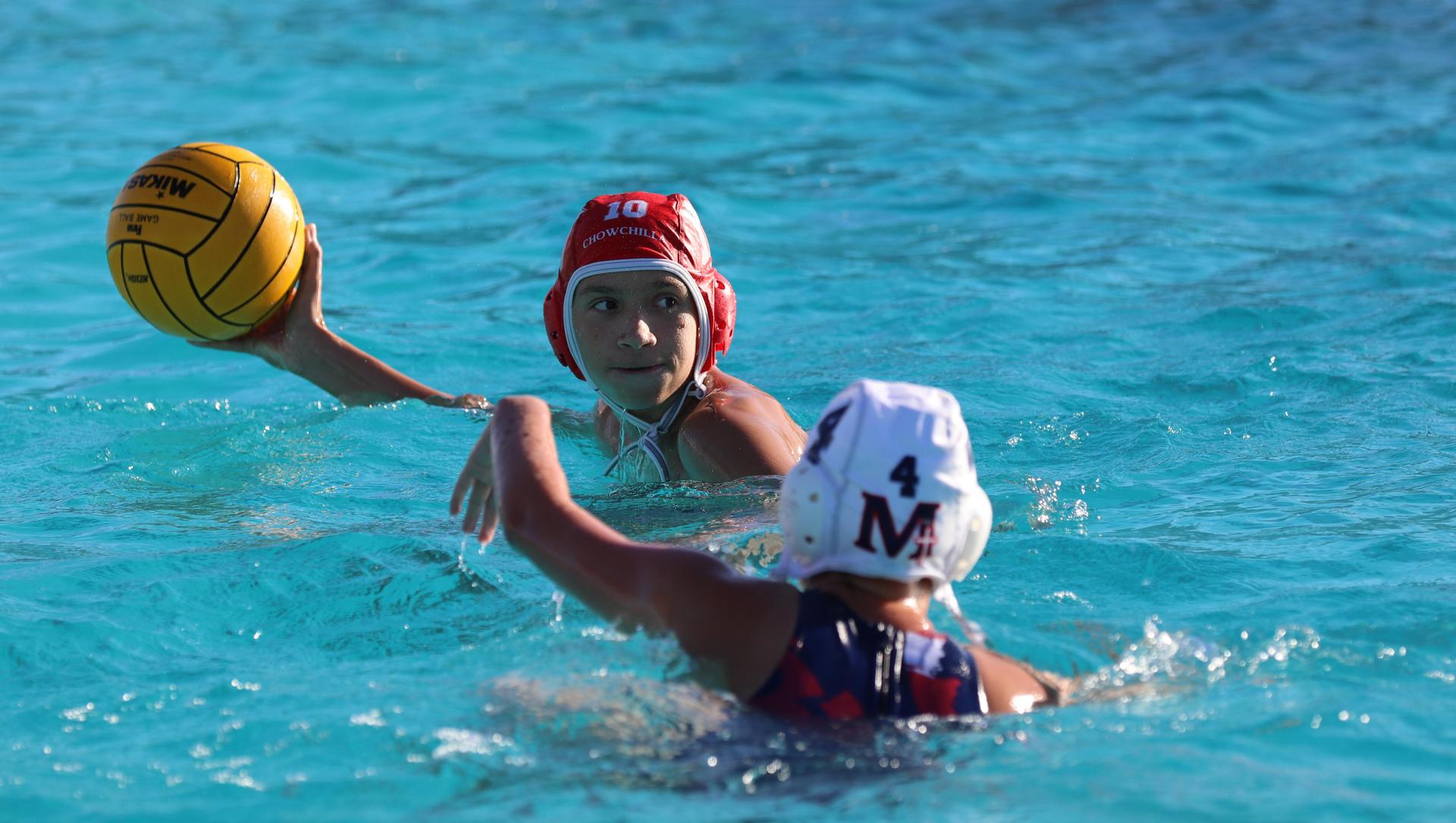 boys water polo players in action against san joaquin memorial