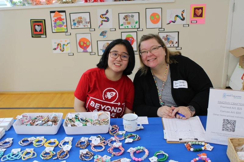 Teacher and student at art show