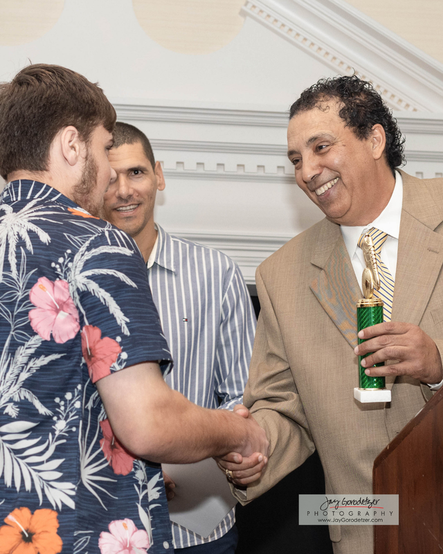 Student Receiving award from Athlete Director Jalal
