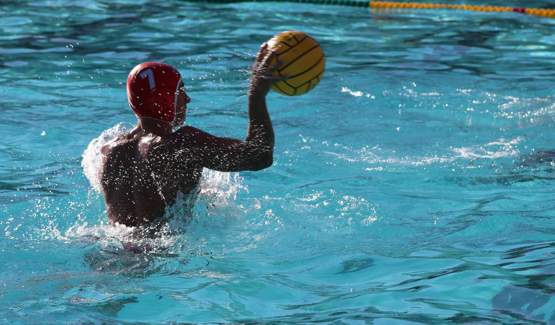 boys water polo players in action against hoover